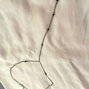 Dainty beaded choker with with a an extra drop down the chest -